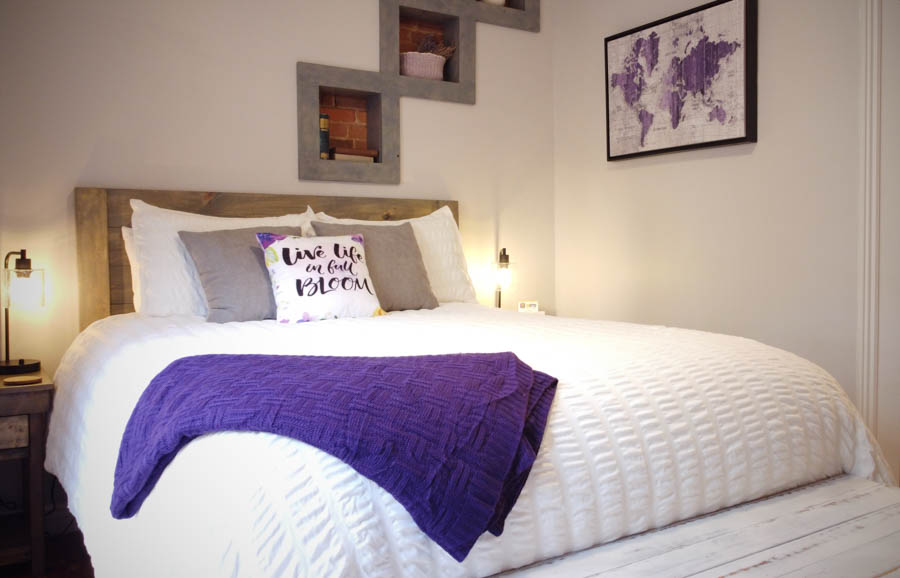 bed with purple throw