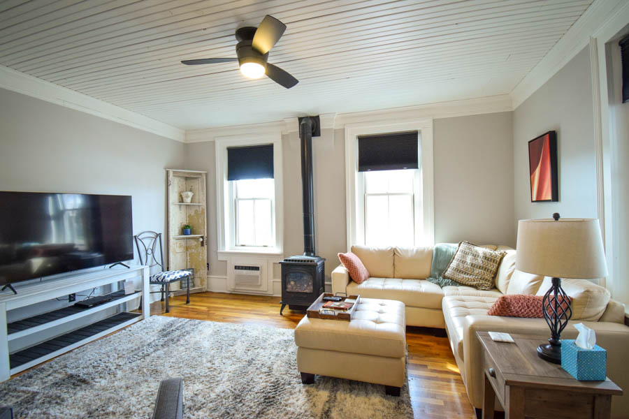 family room at copper house with comfortable seating, large screen tv and fire stove