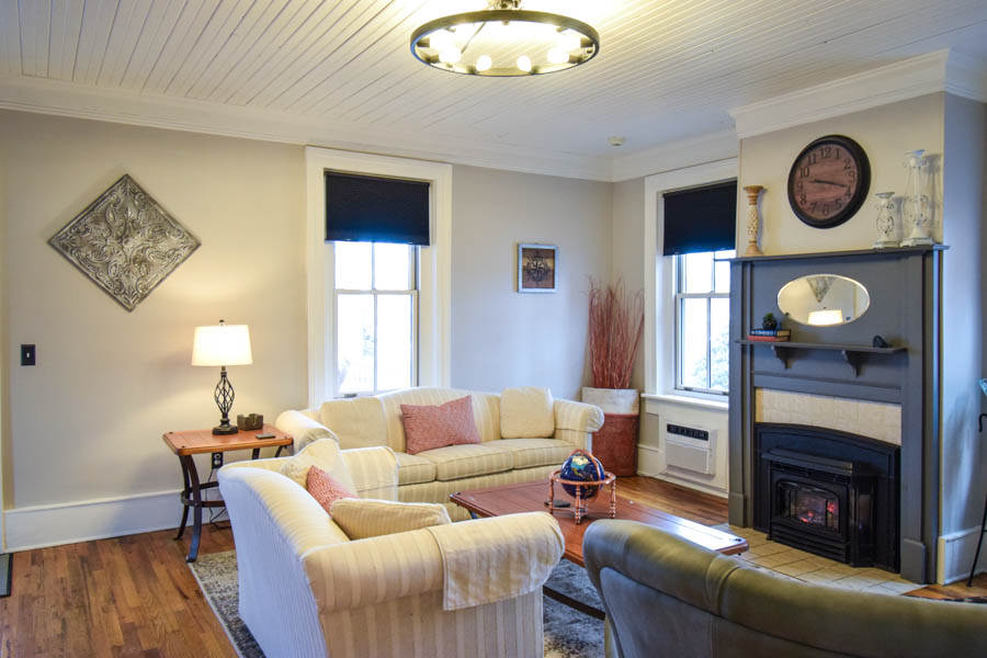 family room at copper house with comfortable seating, large screen tv and fire stove