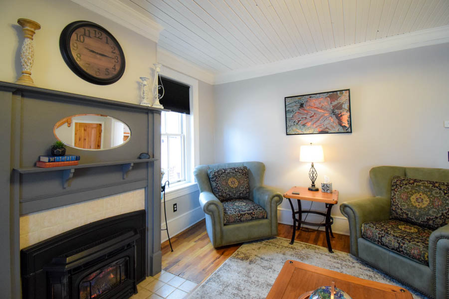family room at copper house with comfortable seating, large screen tv and fire stove